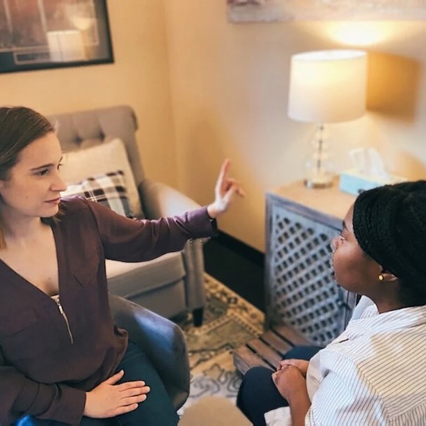 A therapist guiding a client through an EMDR eye movement session in a cozy office.